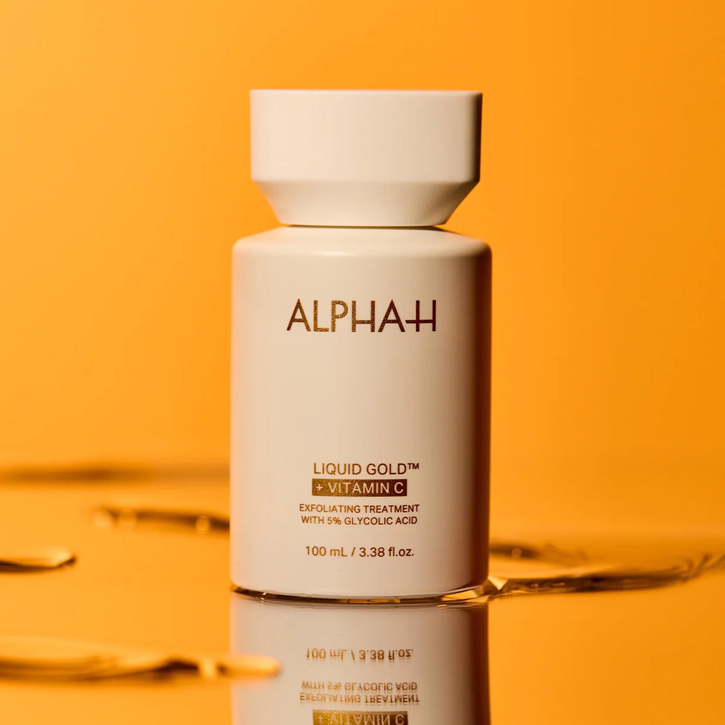 Alpha+ Liquid Gold skincare bottle on an orange background