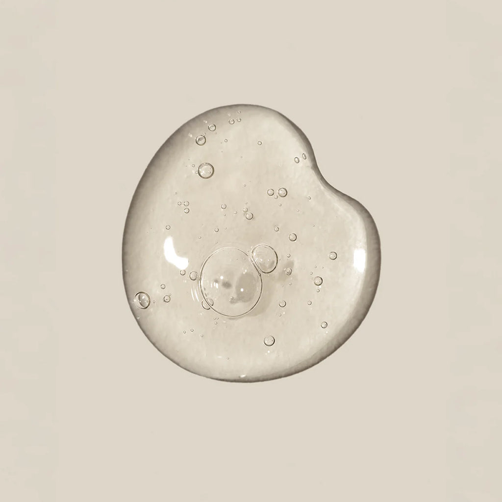 Clear gel or cream with bubbles on a beige background