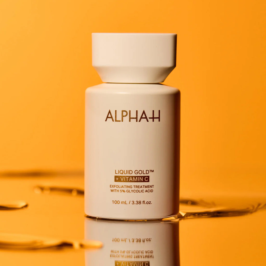 Alpha+ Liquid Gold skincare bottle on an orange background