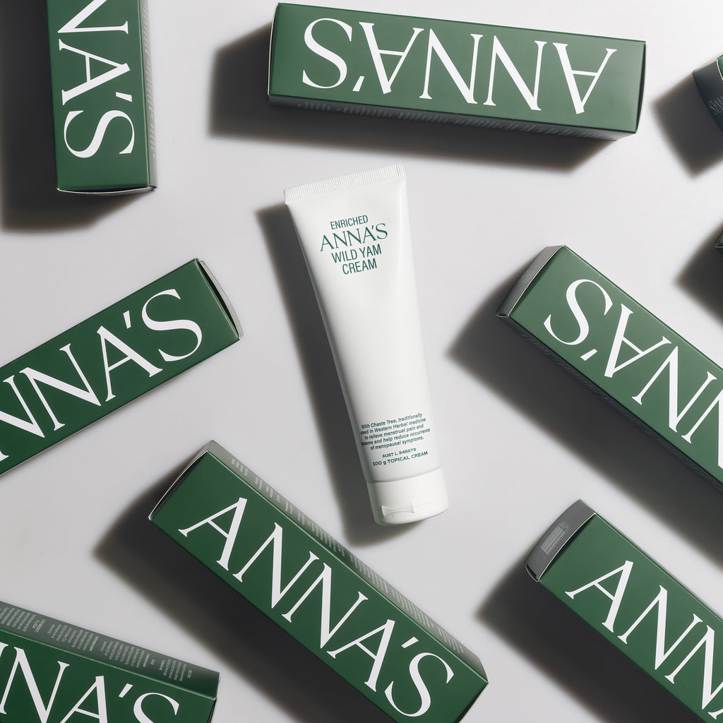 White tube of cream with 'ANNA'S' branding surrounded by green boxes on a light gray background