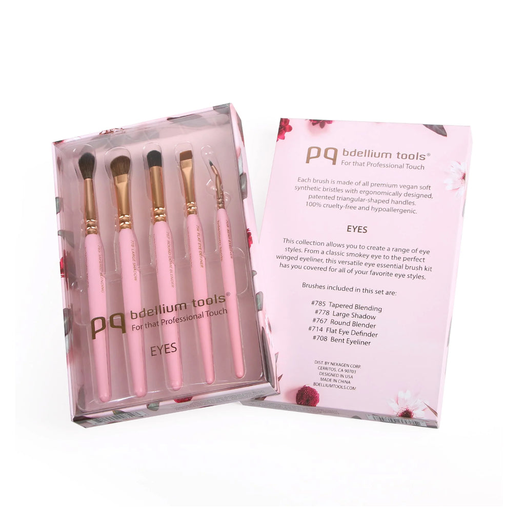 Set of pink makeup brushes with packaging displaying brand name and product details.