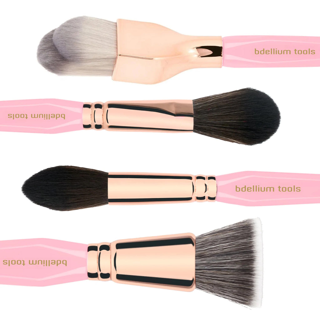 Set of makeup brushes with pink handles and rose gold ferrules on a white background, branded 'bdellium tools'.