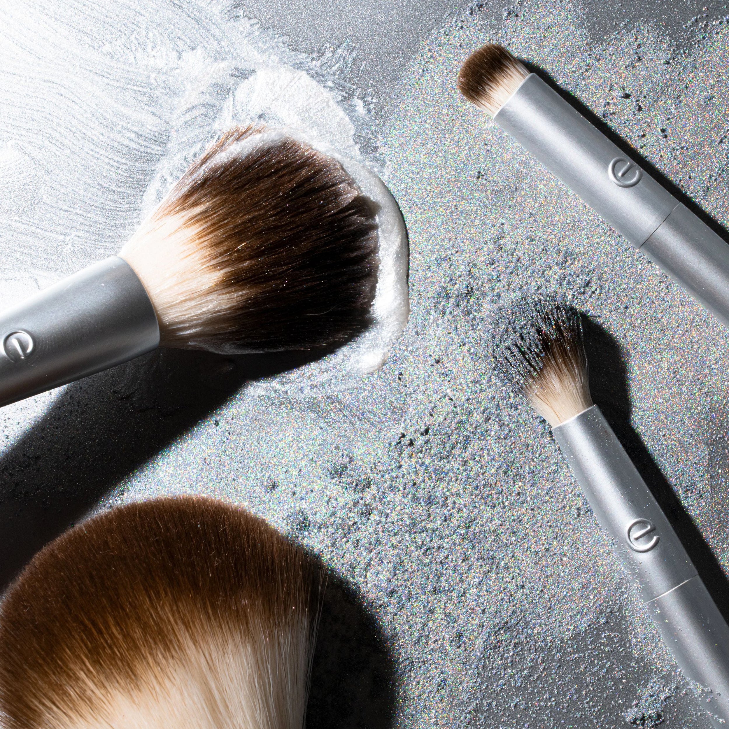 Makeup brushes on a textured surface with visible bristle details