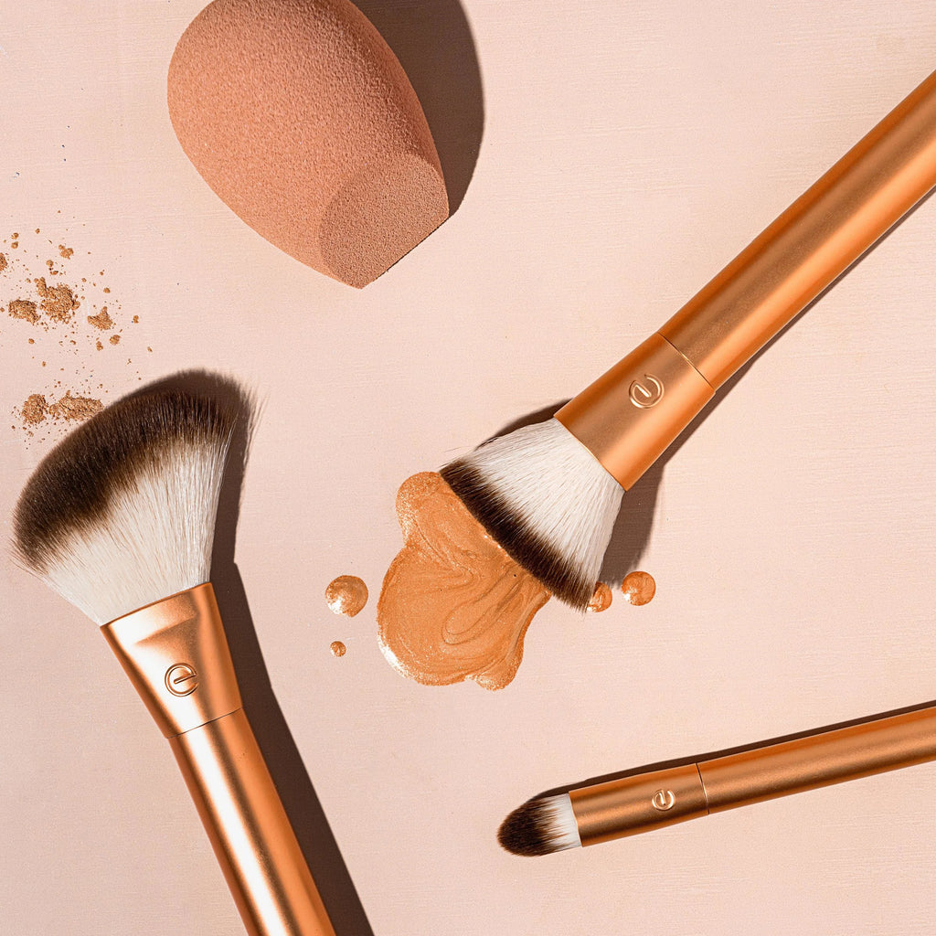 Makeup brushes with beige powder on a matching background