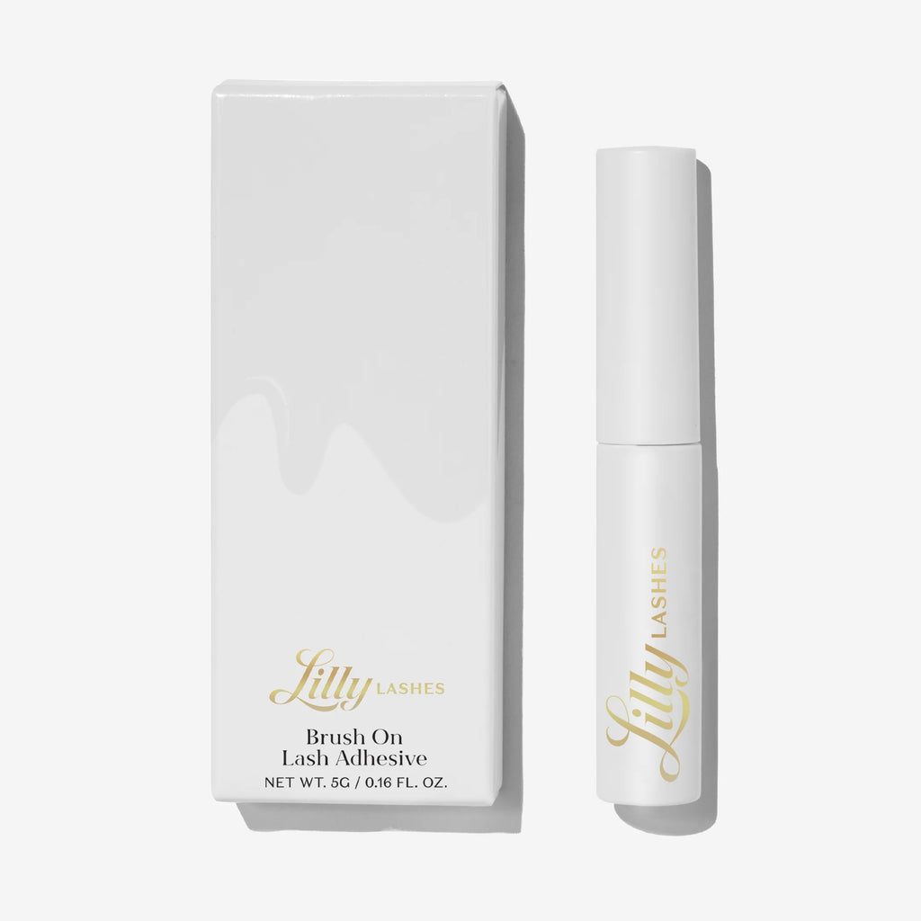 Lilly Lashes brush on lash adhesive with packaging on a white background