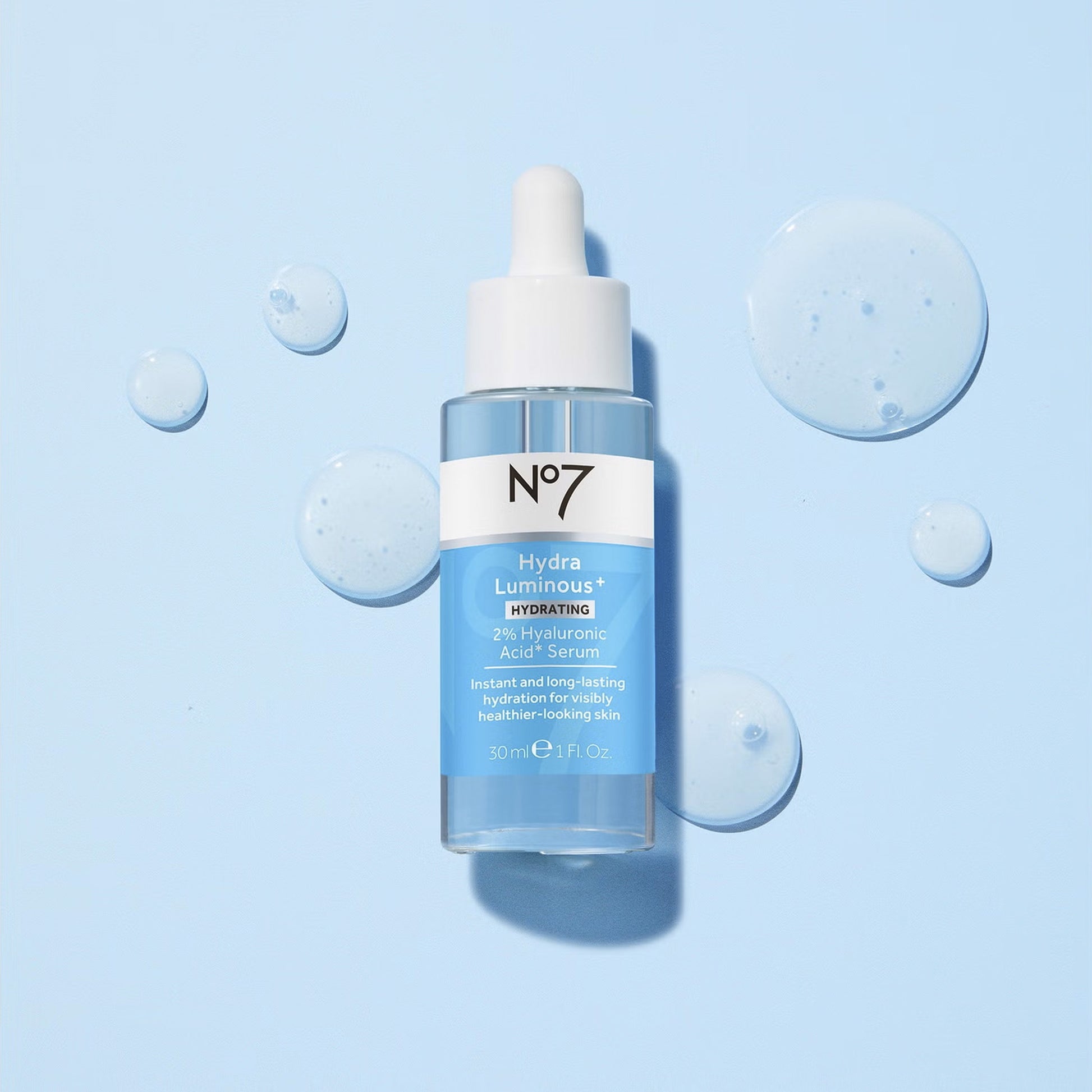 No7 Hydra Luminous serum bottle on a light blue background with bubbles