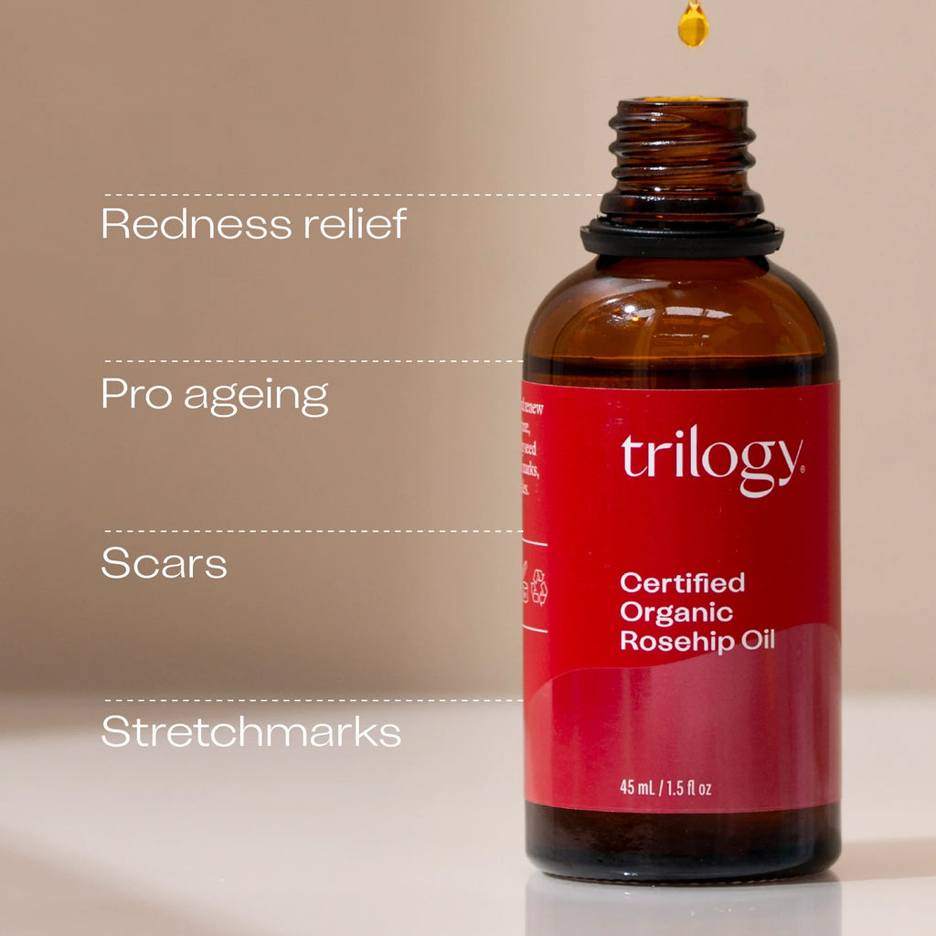Bottle of Trilogy Certified Organic Rosehip Oil with text on a beige background